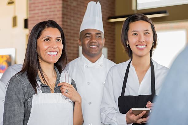 istock Retaurant chef and waitresses having staff meeting with manager 472161257