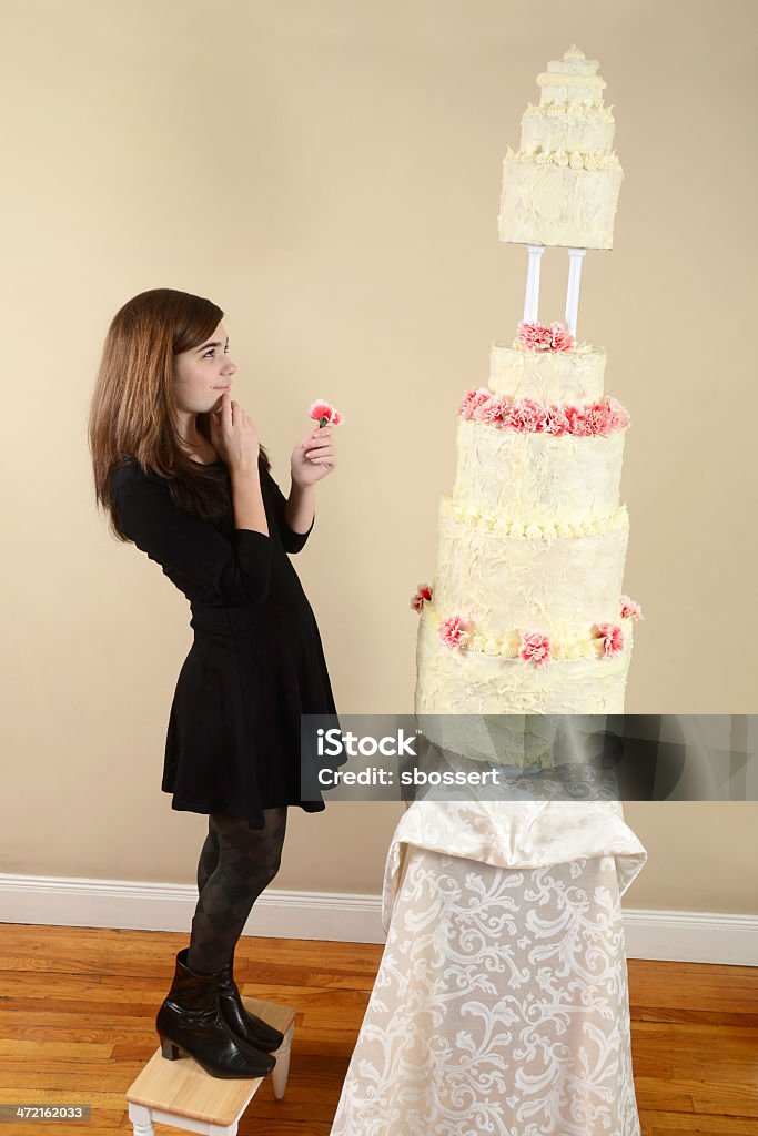 Chica con un pastel de altura - Foto de stock de Alto - Descripción física libre de derechos