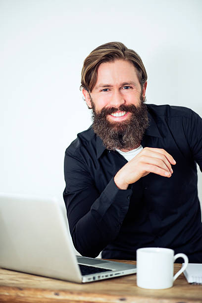 istock Smiling Happy bearded Man working at desk 472162071