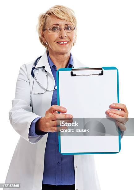 Mature Smiling Female Doctor Studio Portrait Stock Photo - Download Image Now - Close-up, Doctor, Portrait