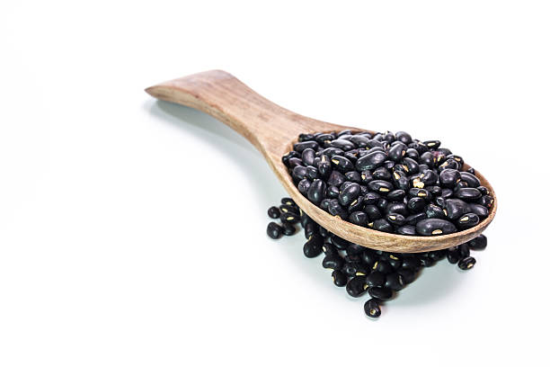 istock black beans in wooden spoon 472162634