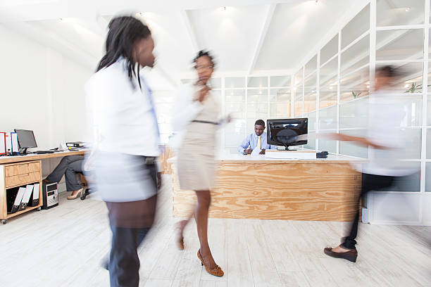 istock Busy African office with people walking around. 472162869
