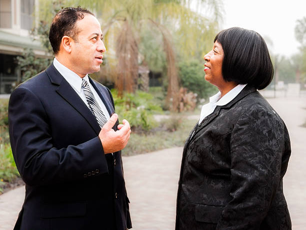 istock Diverse Business Couple Talking 472163553