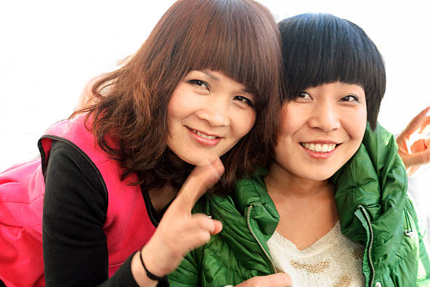 istock Two young Asian woman with a smile 472163981