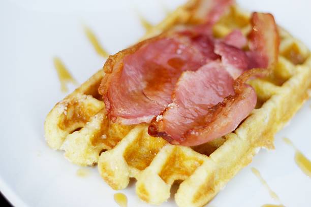 Waffle with bacon and maple syrup stock photo