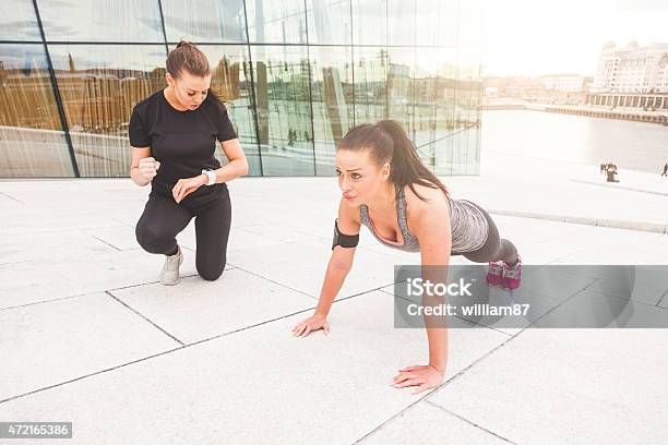 Woman Doing Pushups Exercises With Her Personal Trainer Stock Photo - Download Image Now