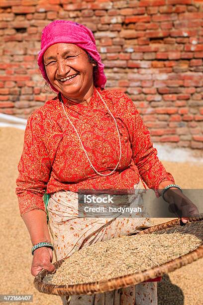 Nepali Woman Sifting A Rice Stock Photo - Download Image Now - Adult, Adults Only, Asia