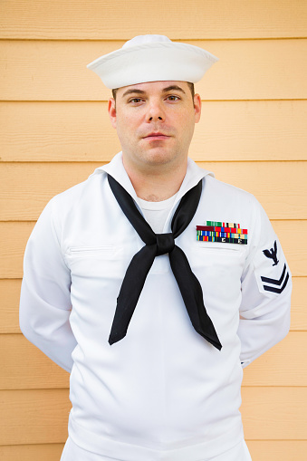 Portrait of a young American marine deck sailor in white uniform.