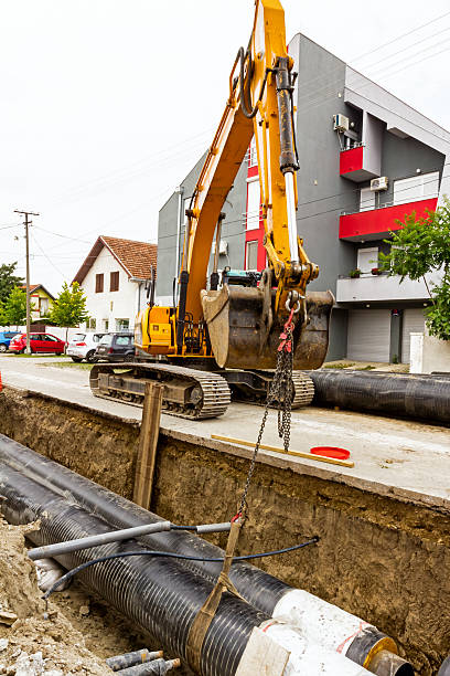 istock Yellow excavator at construction site in urban settlement 472167692