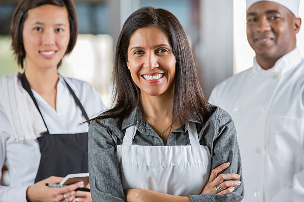 istock Friendly waitstaff and chef in modern restaurant 472168779