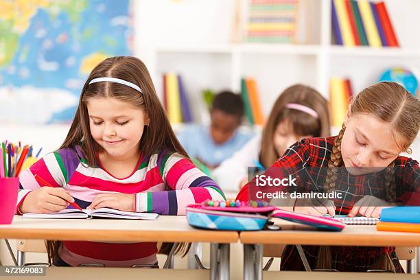 School Children Are Sitting In The Classroom And Writing Stock Photo - Download Image Now