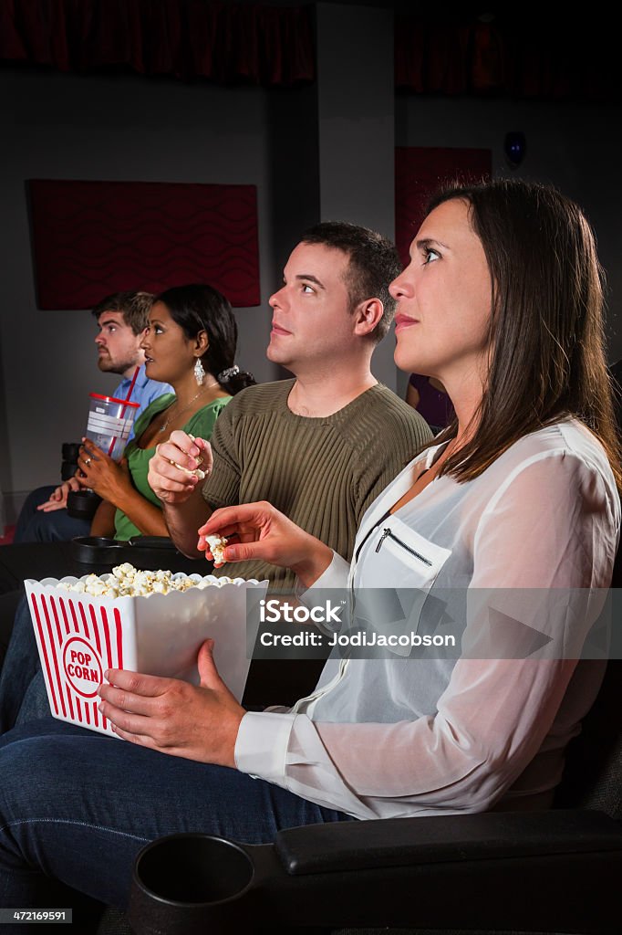 Night at the movies Movie goers are enjoying movie with popcorn and soda.  RM  rr 30-39 Years Stock Photo