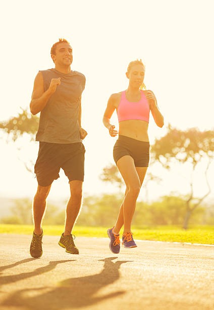 istock Couple running in the park at sunrise 472170257