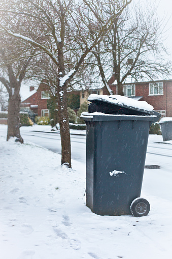 Black garbage bin for colection in an English neighbourhood