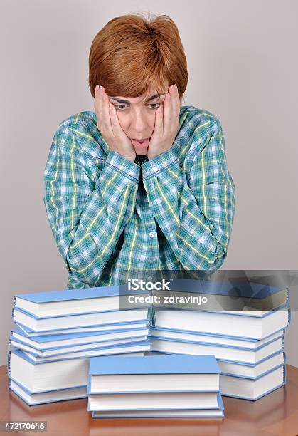 Surprised And Scared Woman And Books Stock Photo - Download Image Now - 2015, Adult, Adults Only