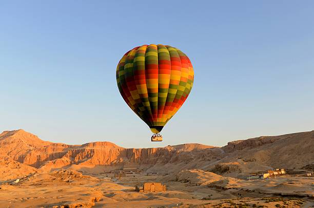 Hot air Balloon in Egypt Hot air balloon lifting off in luxor egypt with the temple of hatshepsut in background hatshepsut photos stock pictures, royalty-free photos & images