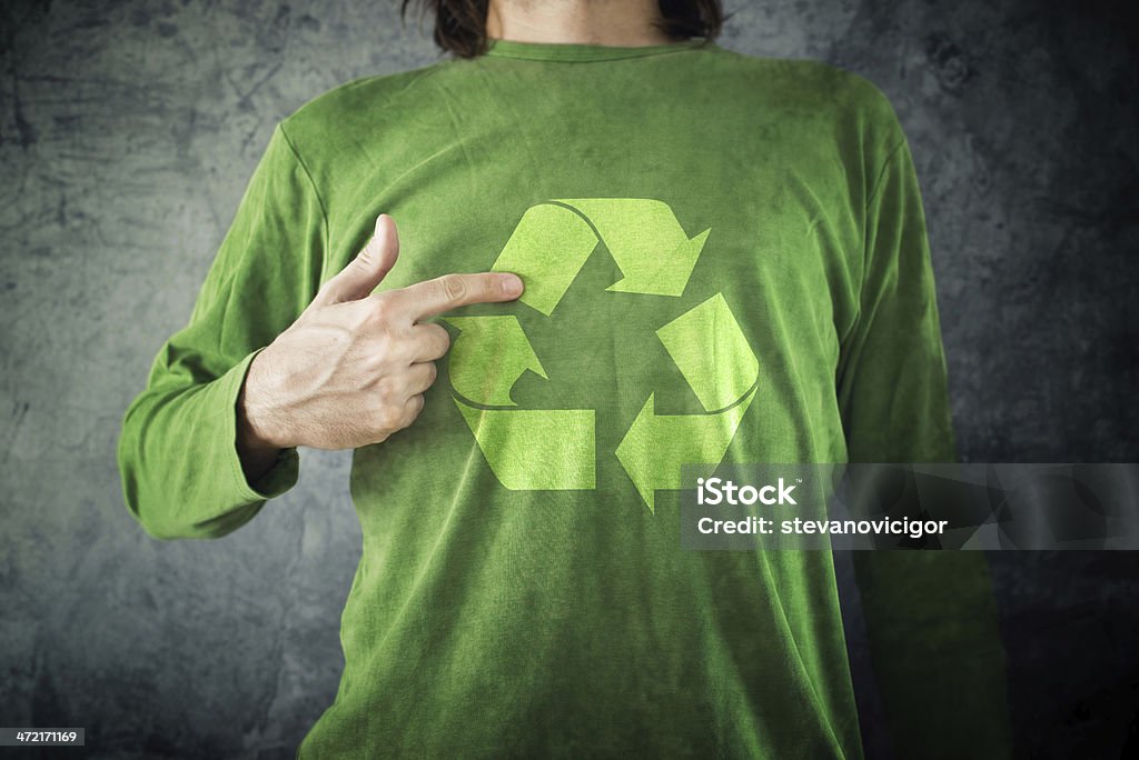 RECYCLE. Man pointing to recycling symbol printed on his shirt Man pointing to RECYCLE symbol printed on his shirt, environment preservation activist. Activist Stock Photo