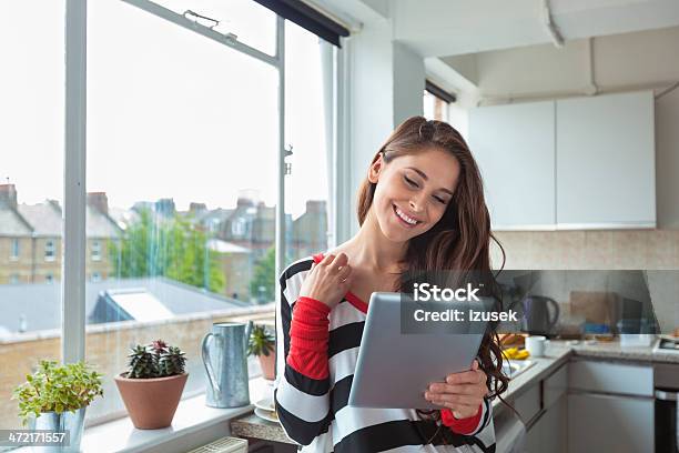 Girl Using Digital Tablet Stock Photo - Download Image Now - Digital Tablet, Home Interior, One Woman Only