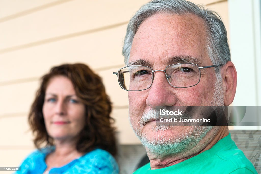 Mature Couple Happy mature couple posing looking at the camera Serious Stock Photo