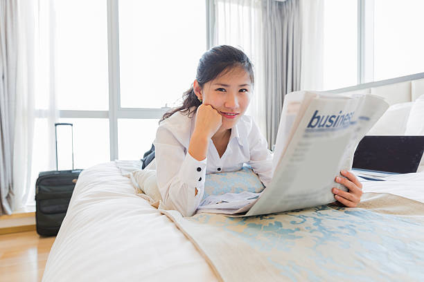 istock asian businesswoman working on bed 472172653