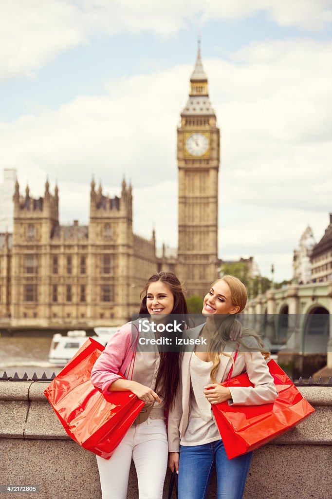 Shopping in London Outdoor portrait of two happy young women with Houses of Parliament and Big Ben in the background. 20-24 Years Stock Photo