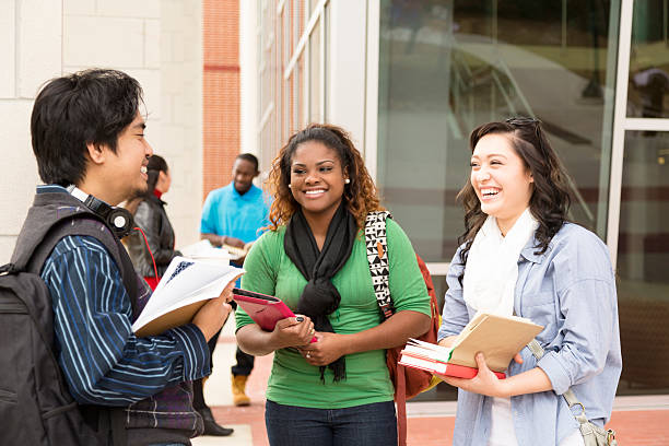 istock Education: Multi-ethnic college friends hang out before class. 472175209