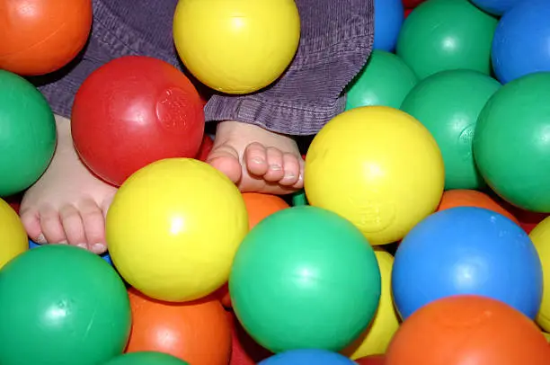 Baby feet in coloured balls