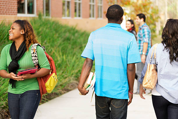 istock Education: Diverse group of college students walk to class. Campus. 472175459