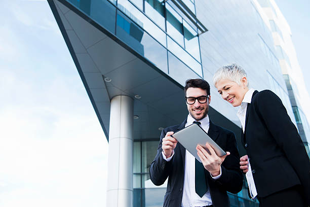 istock Two businesspeople looking at a tablet 472175537