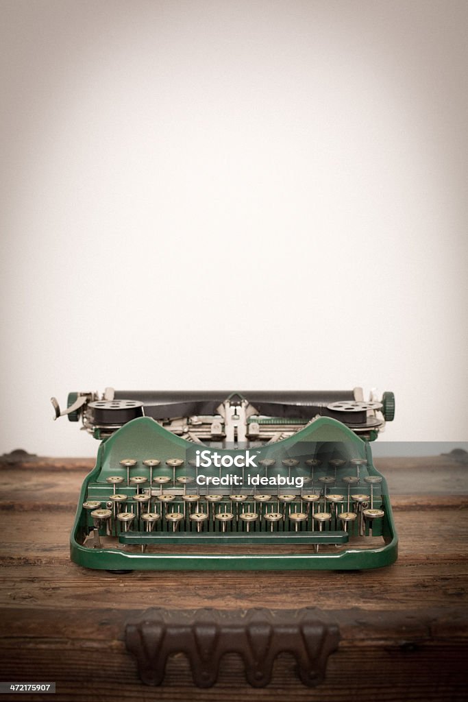 Color Image of Green, Vintage Manual Typewriter, With Copy Space Color image of a vintage, green, manual typewriter, sitting on wood trunk, with room for your text. Green Color Stock Photo