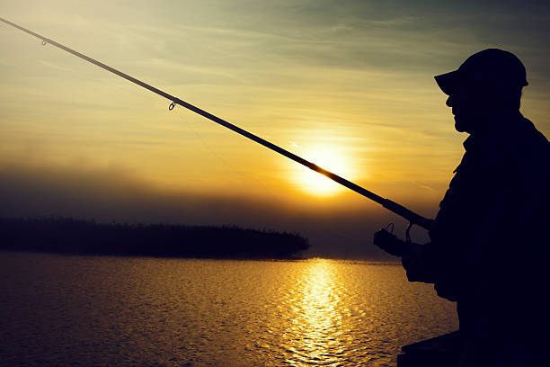 istock man fishing at sunrise 472176113