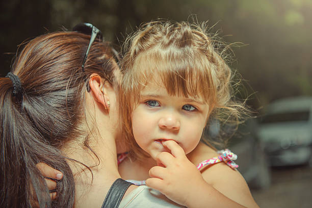 Portrait of young mother with her little baby girl