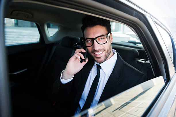 istock Businessman talking on phone at the car 472176237