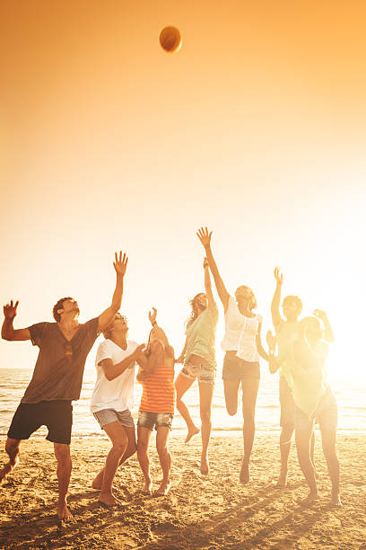 istock group of friends jumping on the beach 472176655