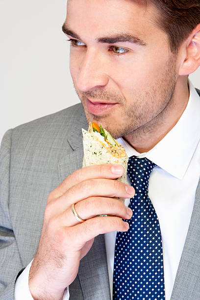 istock Businessman Eating a Wrap 472176957