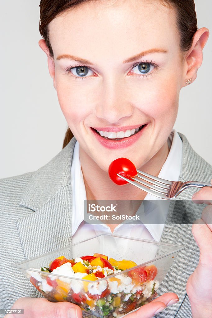 Businesswoman Eating a Salad Pot Young business woman enjoying a salad pot on the go 30-39 Years Stock Photo