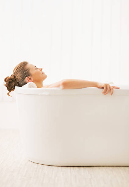 istock young woman relaxing in bathtub 472177601