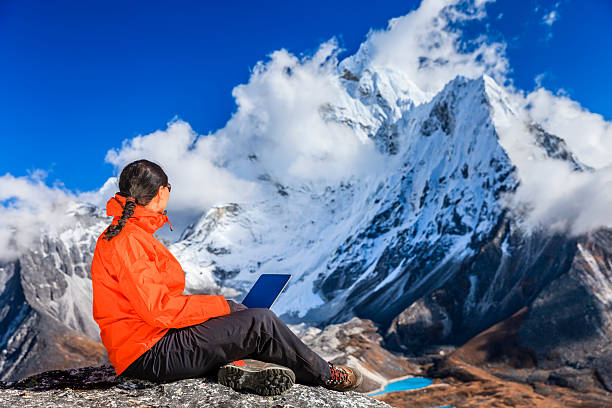 istock Woman is using laptop in Mount Everest National Park, Nepal 472178151