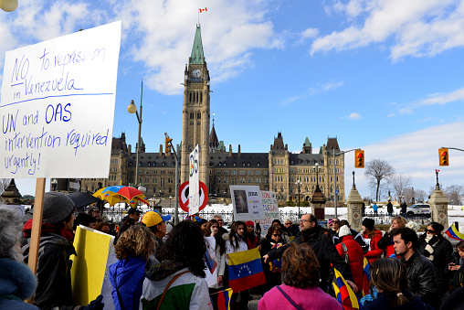 Ottawa, Canada - February 22, 2014: Venezuelans gather in front of Parliament Hill in Ottawa to bring attention to the plight of their countrymen who are protesting against the Venezuelan government. Recently protesters in Venezuela have been killed and the Venezuelan government has been censoring the media.