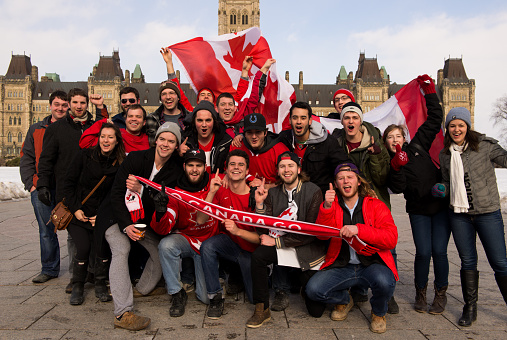Ottawa, Canada - February 23, 2014:  Canadians gather on Parliament Hill in Ottawa at 10 am to celebrate Canada's defense of Olympic hockey gold with a 3-0 win over Sweden in the final game.  The game started at 7 am local time.