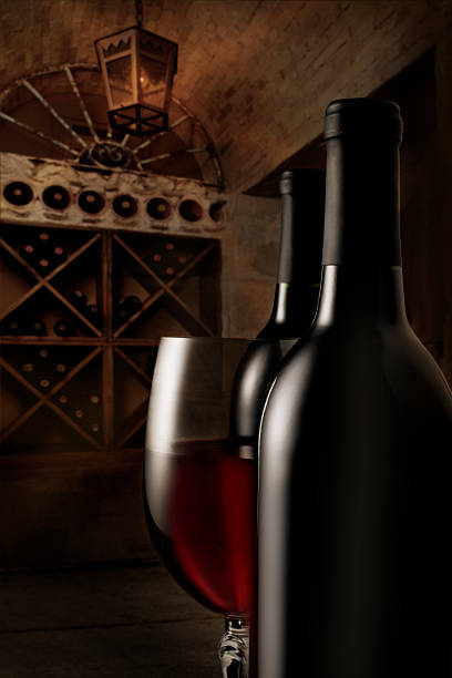 istock Red wine and bottles in cellar 472179269