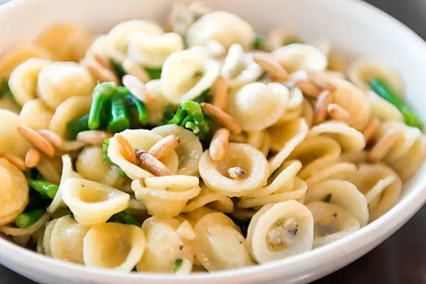 Orecchiette pasta, broccoli, olive oil and herbs topped with pine nuts.