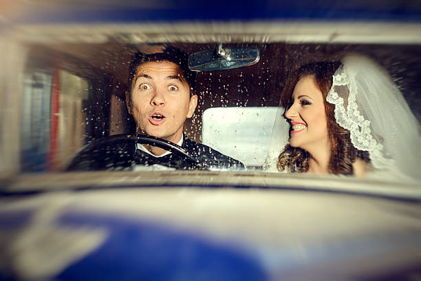 istock funny amazed groom in car 472180017