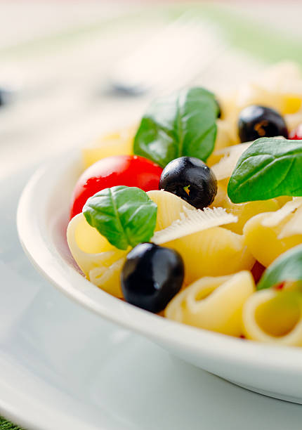 Pasta with fresh tomatoes and olives Pasta with fresh tomatoes and olives cooked selective focus vertical pasta stock pictures, royalty-free photos & images