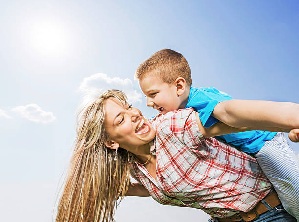 istock Mother piggybacking her son. 472181511