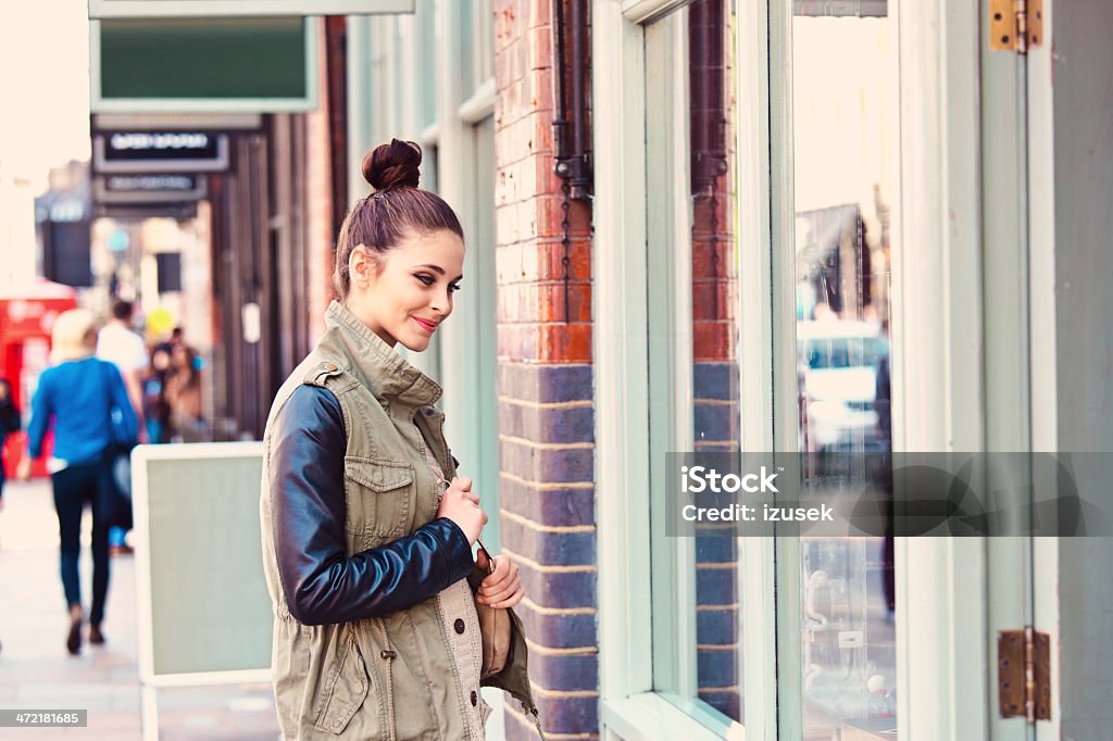 Girl in the city Young smiling woman standing at a shopwindow in the city. 20-24 Years Stock Photo