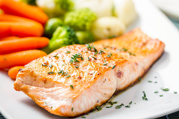 istock Fillet of salmon with mixed vegetables 472182003