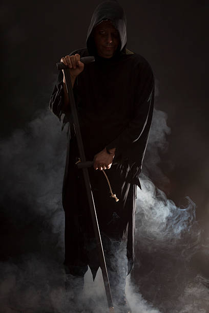 istock Mr. Death holding a scythe 472182153