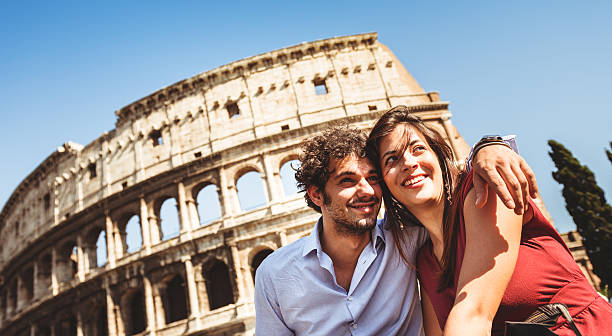 istock Tourist flirting in rome at coliseum 472184199