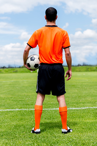 Soccer player looking at the football field